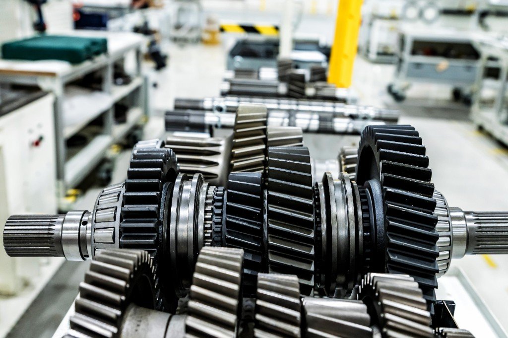Industrial gear shafts lined up in a precision manufacturing facility