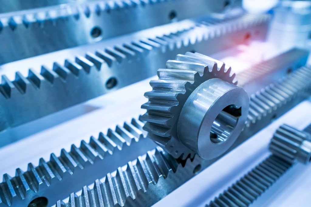 Precision metal spur gear resting on rack gears for industrial power transmission